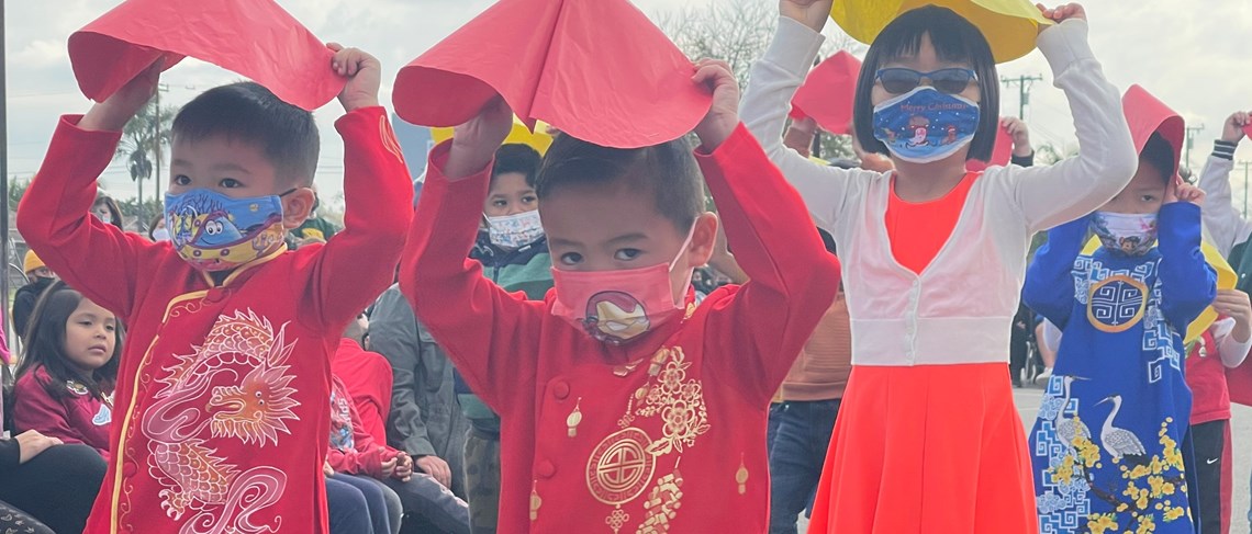 Kindergarten students beautifully perform a traditional dance for Tet